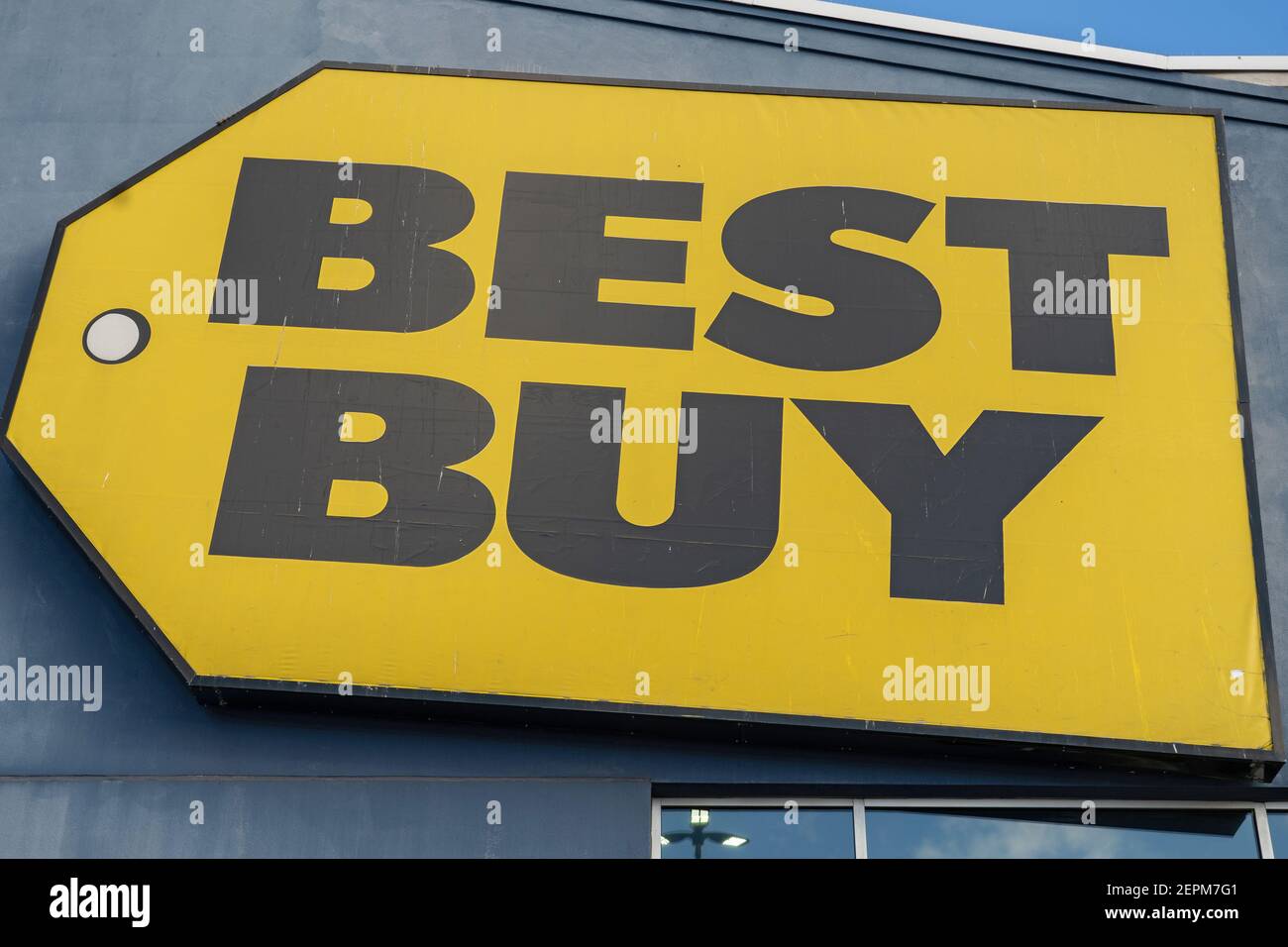 NEW YORK, NY – FEBRUARY 27:  A Best Buy sign and Logo seen above a Best Buy store in Queens on February 27, 2021 in New York City.  Best Buy Co. (BBY) lays off 5,000 workers, the majority of whom worked full-time and adding approximately 2,000 new part-time positions as it shifts focus to online sales.  The pandemic has accelerated Best Buy's transition to selling online said Chief Executive Corie Barry on a call with analysts on Thursday. Credit: Ron Adar/Alamy Live News Stock Photo