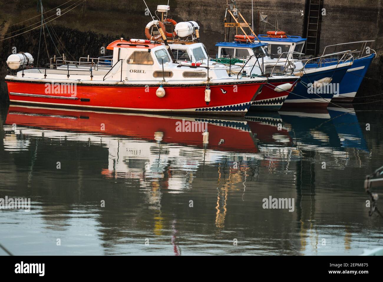 Dublin, Ireland. 26th Feb, 2021. A view of fishing boats moored at Howth Harbor during sunset. Credit: SOPA Images Limited/Alamy Live News Stock Photo