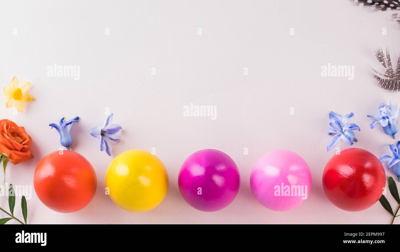 Colorful Easter eggs on a pink background. Bright Easter concept. Copy space. Stock Photo