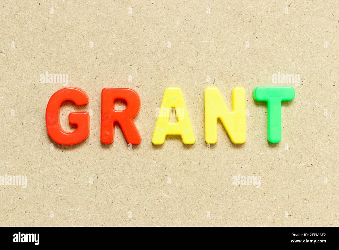 Color alphabet letter with word grant on wood background Stock Photo