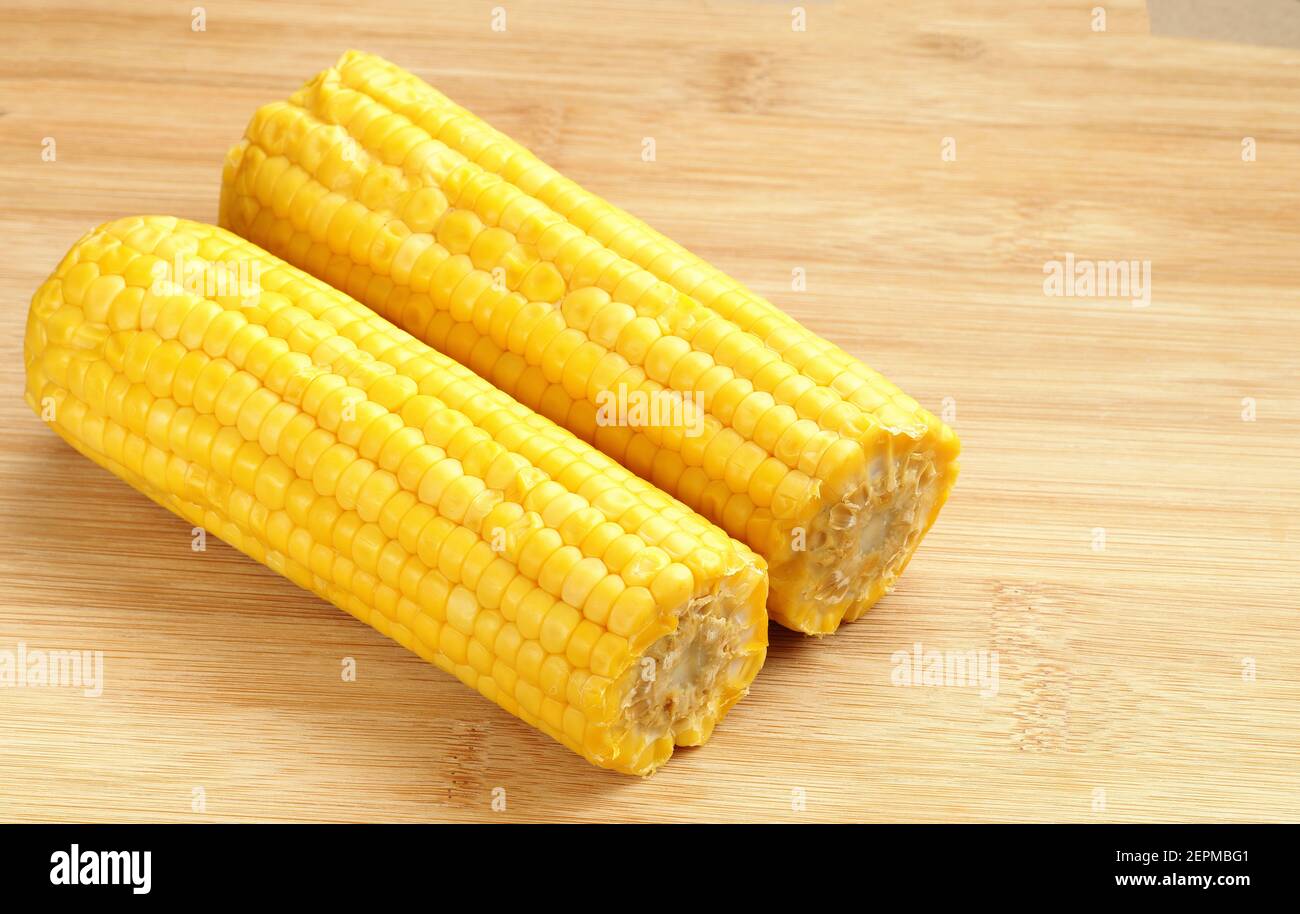Boiled corn pob and sweet popcorn. Ears of cooked sweet corn on a