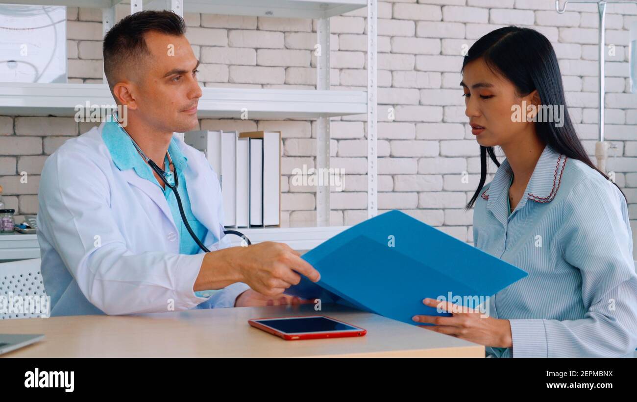 Doctor in professional uniform examining patient at hospital or medical