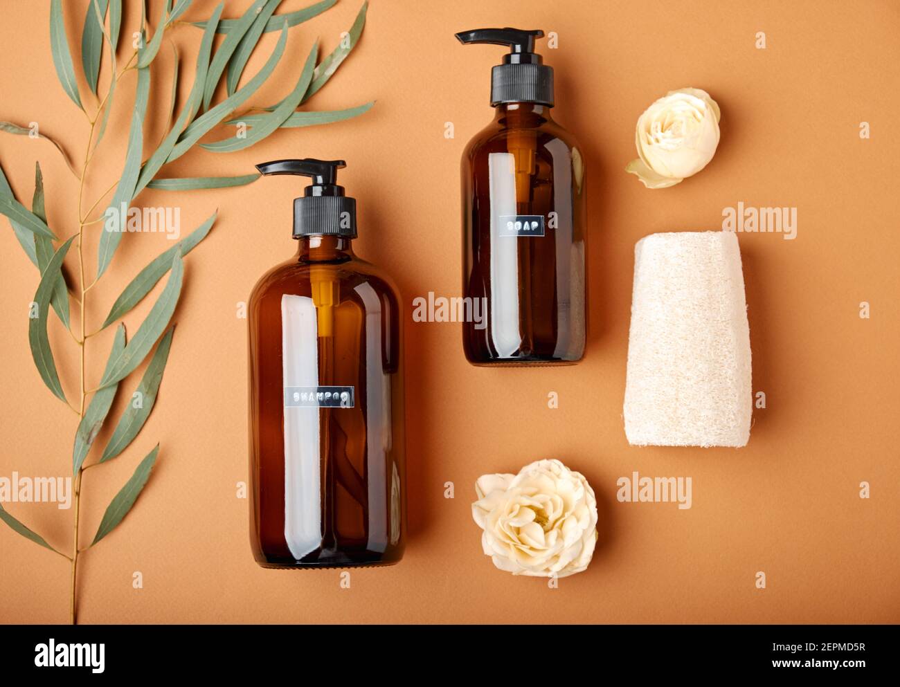 Dark amber glass pump cosmetic bottle and bath accessories Stock Photo