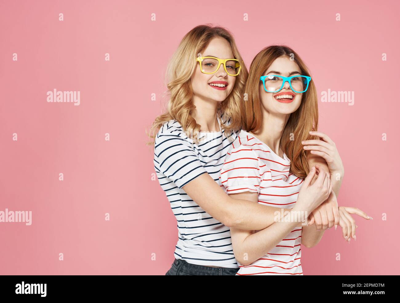 Two Cute Blondes Socializing Joy Hug Lifestyle Fashion Pink Background