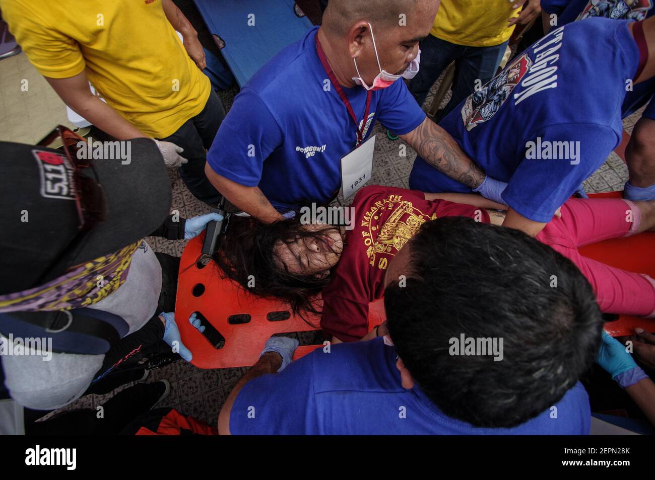 A devotee fainted during the procession is rushed to the nearest first aid station in Carriedo in Manila, Philippines. Millions of devotees attend the yearly Traslacion of the Black Nazarene on January 9, 2018. (Photo by Larry Monserate Piojo/Sipa USA) Stock Photo