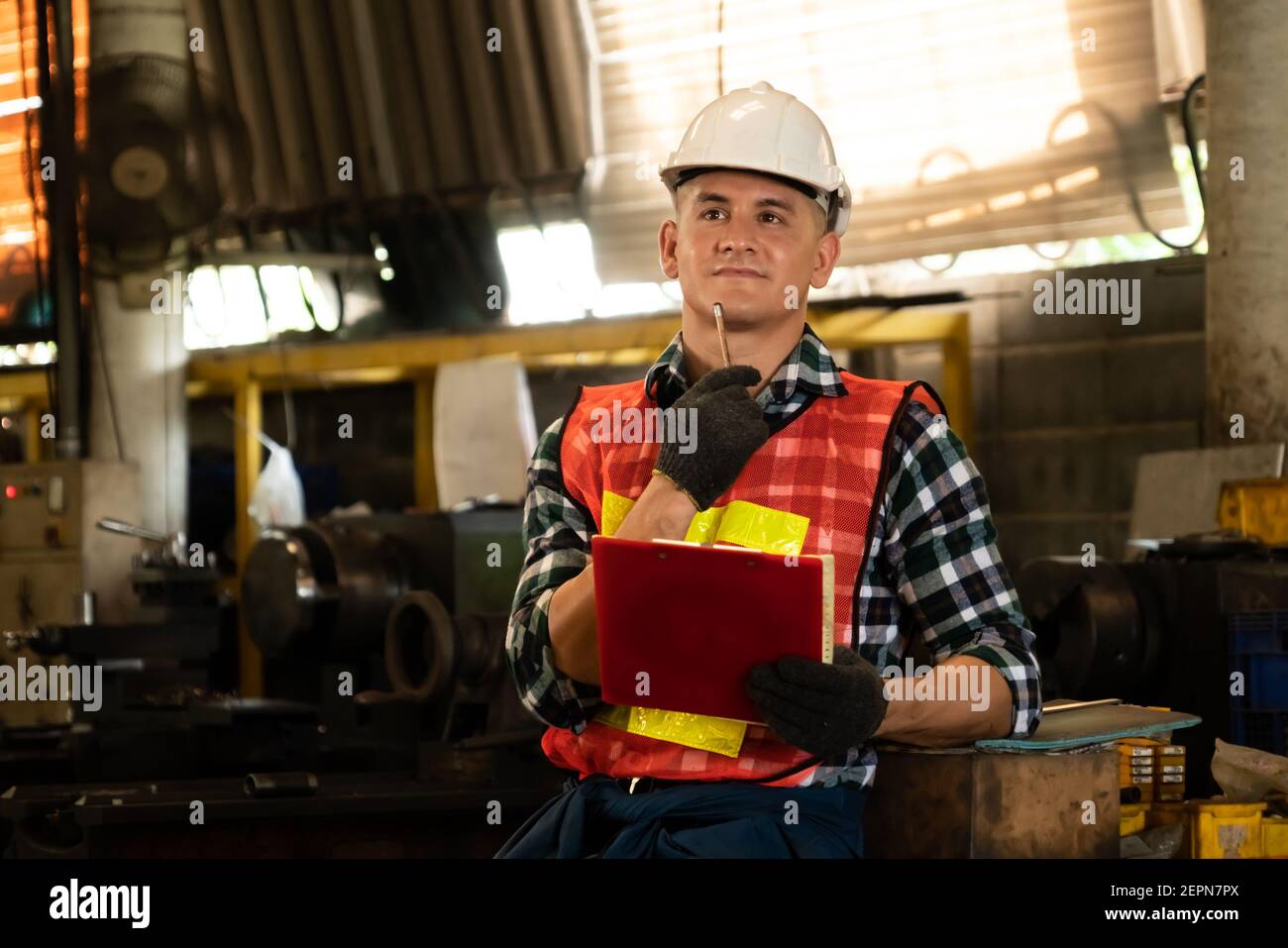 Manufacturing worker working with clipboard to do job procedure