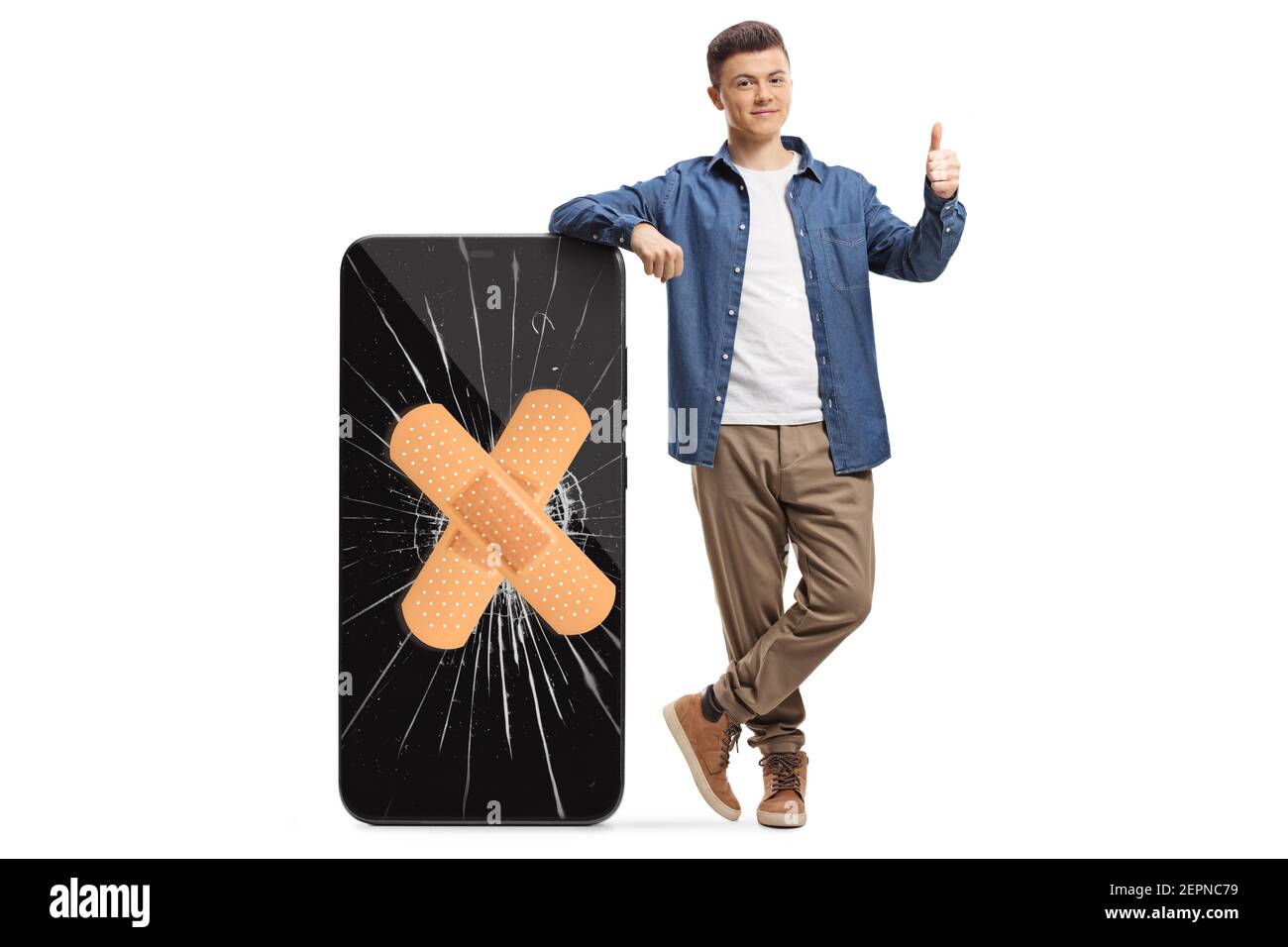 Full length portrait of a guy leaning on a phone with cracked screen and bandage and showing thumbs up isolated on white background Stock Photo
