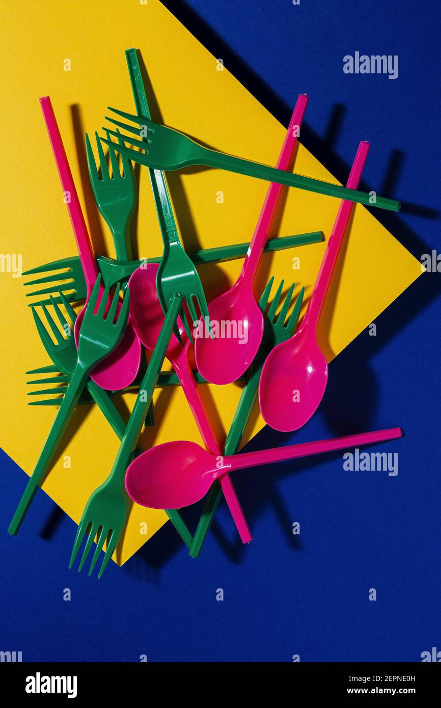 Overhead view of bright colorful eco friendly cutlery near yellow