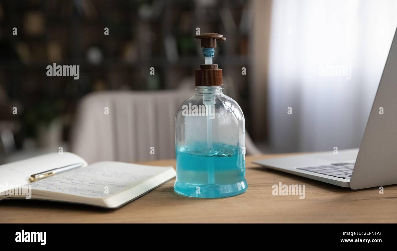 Close up of workplace with antibacterial sanitizer bottle Stock Photo