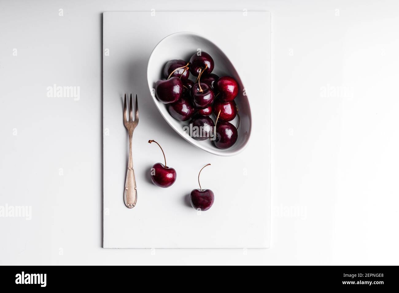 High angle of healthy ripe tasty cherries in ceramic bowl placed on ...