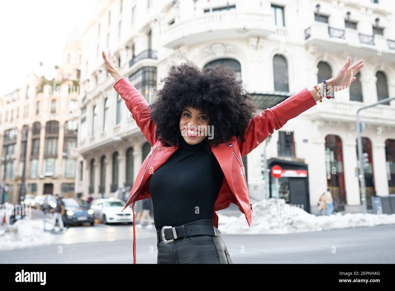 Black Woman with afro hair on the street and smiling at camera Stock ...