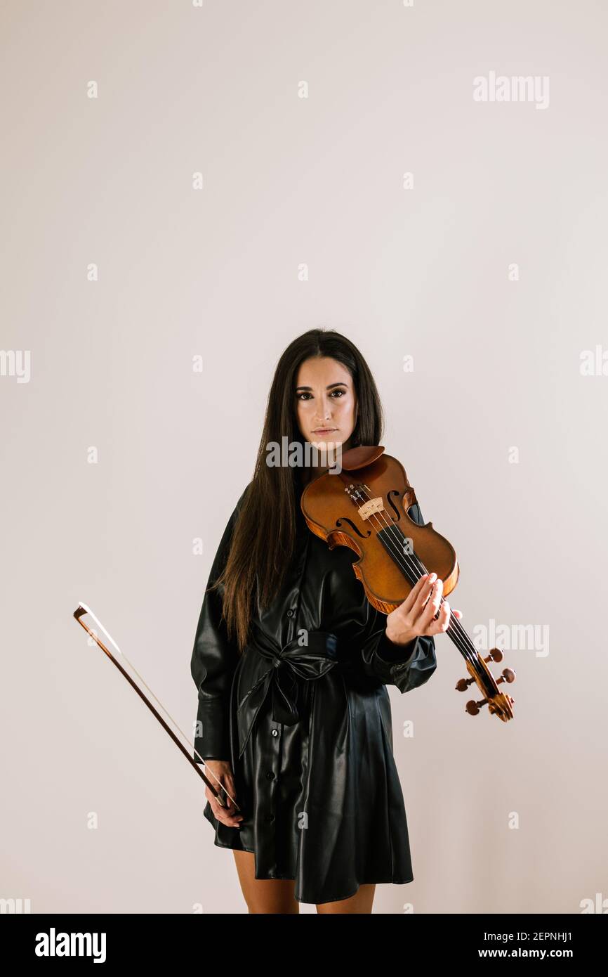 String Instruments While Playing Serious artist playing stringed musical instrument while practicing ...