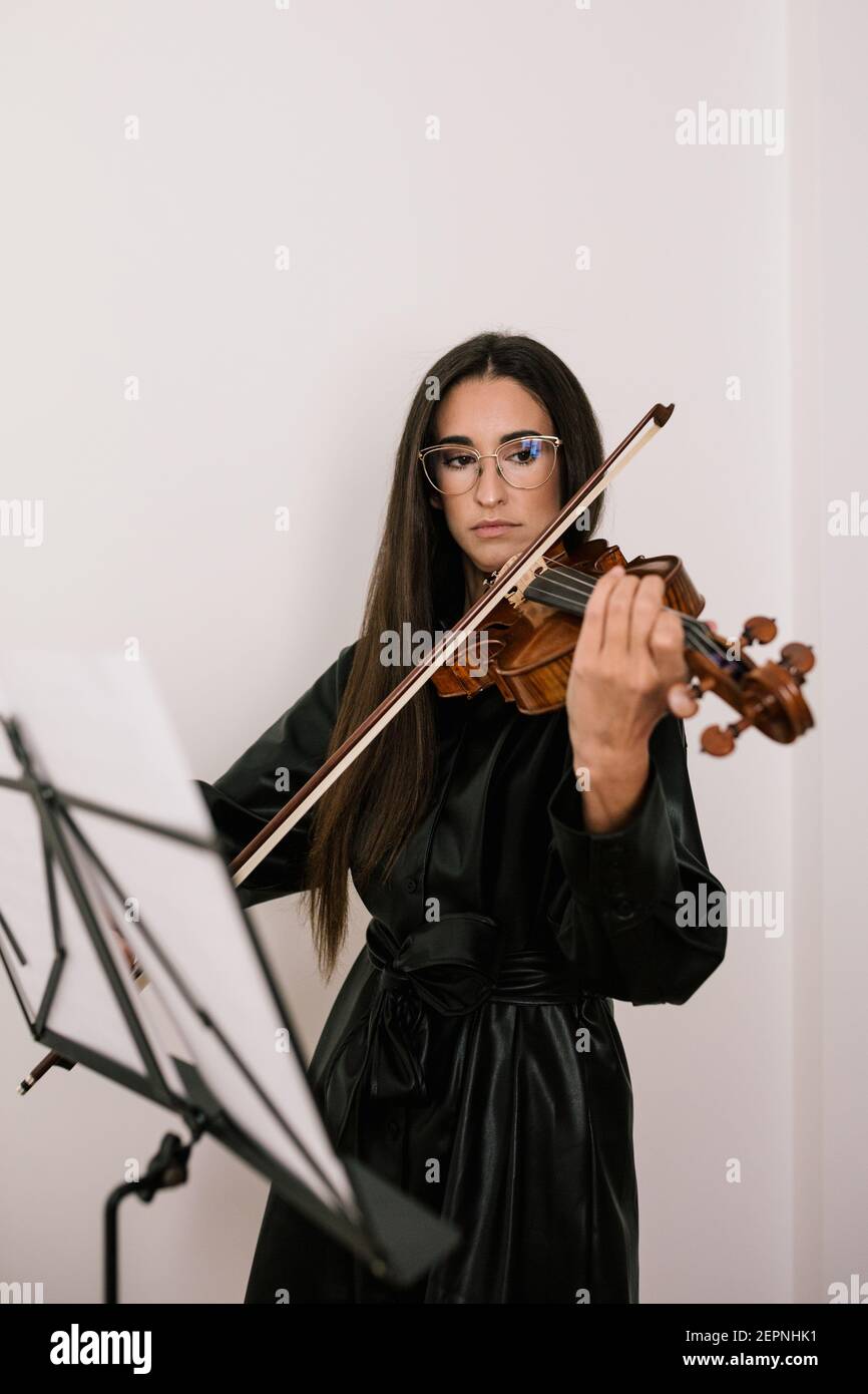Serious artist playing stringed musical instrument while practicing ...