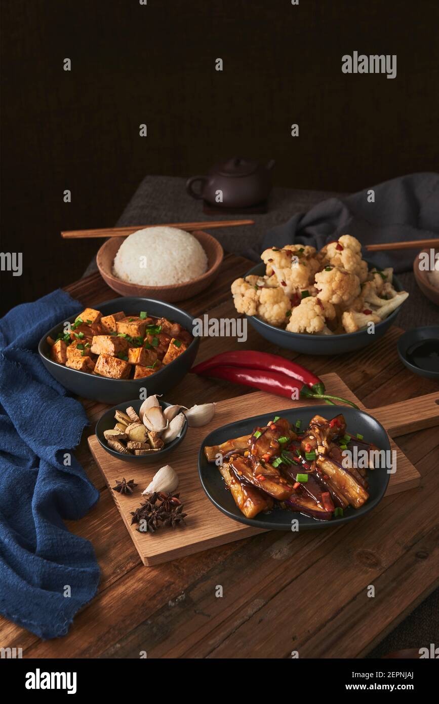 Mala tofu and yuxiang, chinese vegan dishes, by a bowl of rice, cauliflower, soy