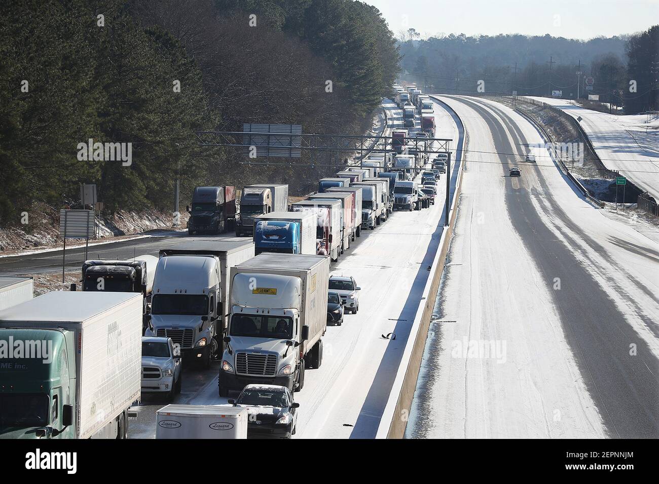 Tractor trailer trucks and motorists are stuck in the ice while all westbound lanes are closed on I-20 West at the Almon Road exit after multiple tractor trailer trucks jackknifed in the winter conditions on Wednesday, January 17, 2018, in Covington, Ga. (Photo by Curtis Compton/Atlanta Journal-Constitution/TNS/Sipa USA) Stock Photo