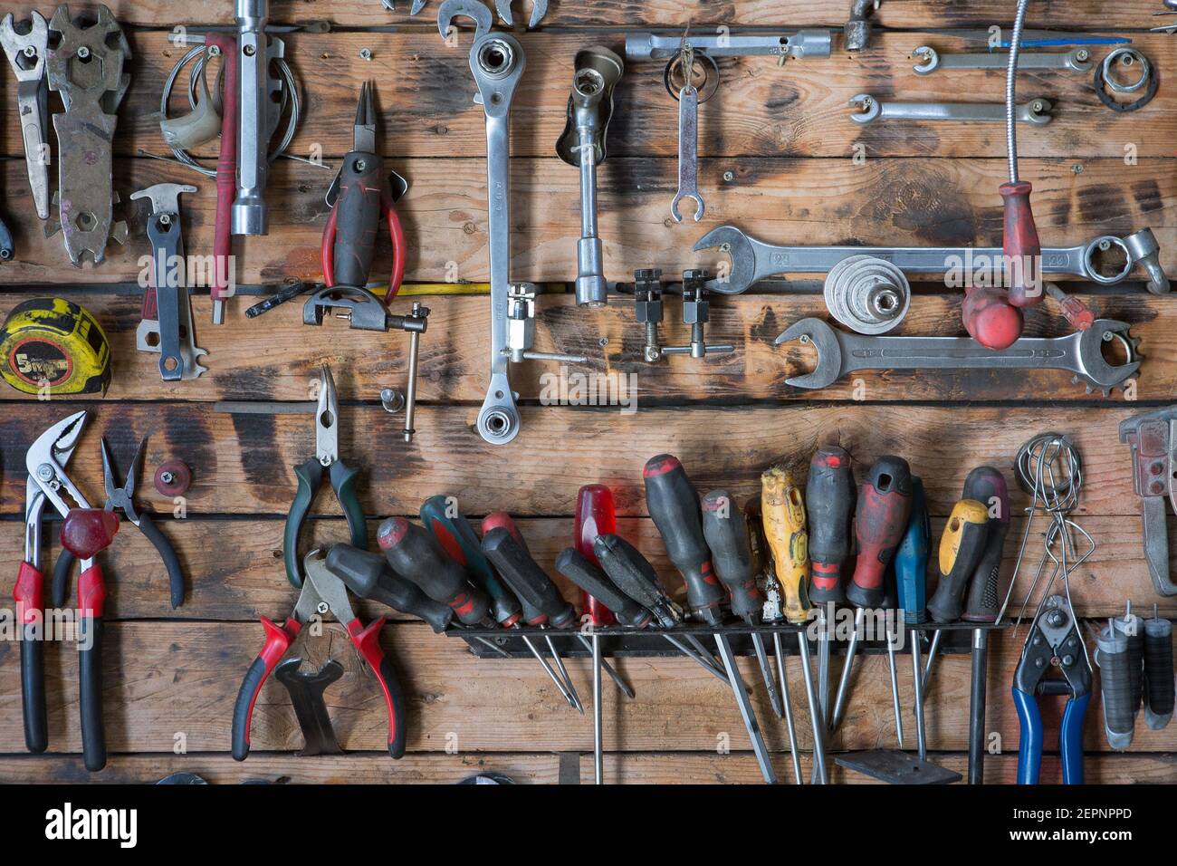 Set of different iron instruments for repairing on lumber wall in ...