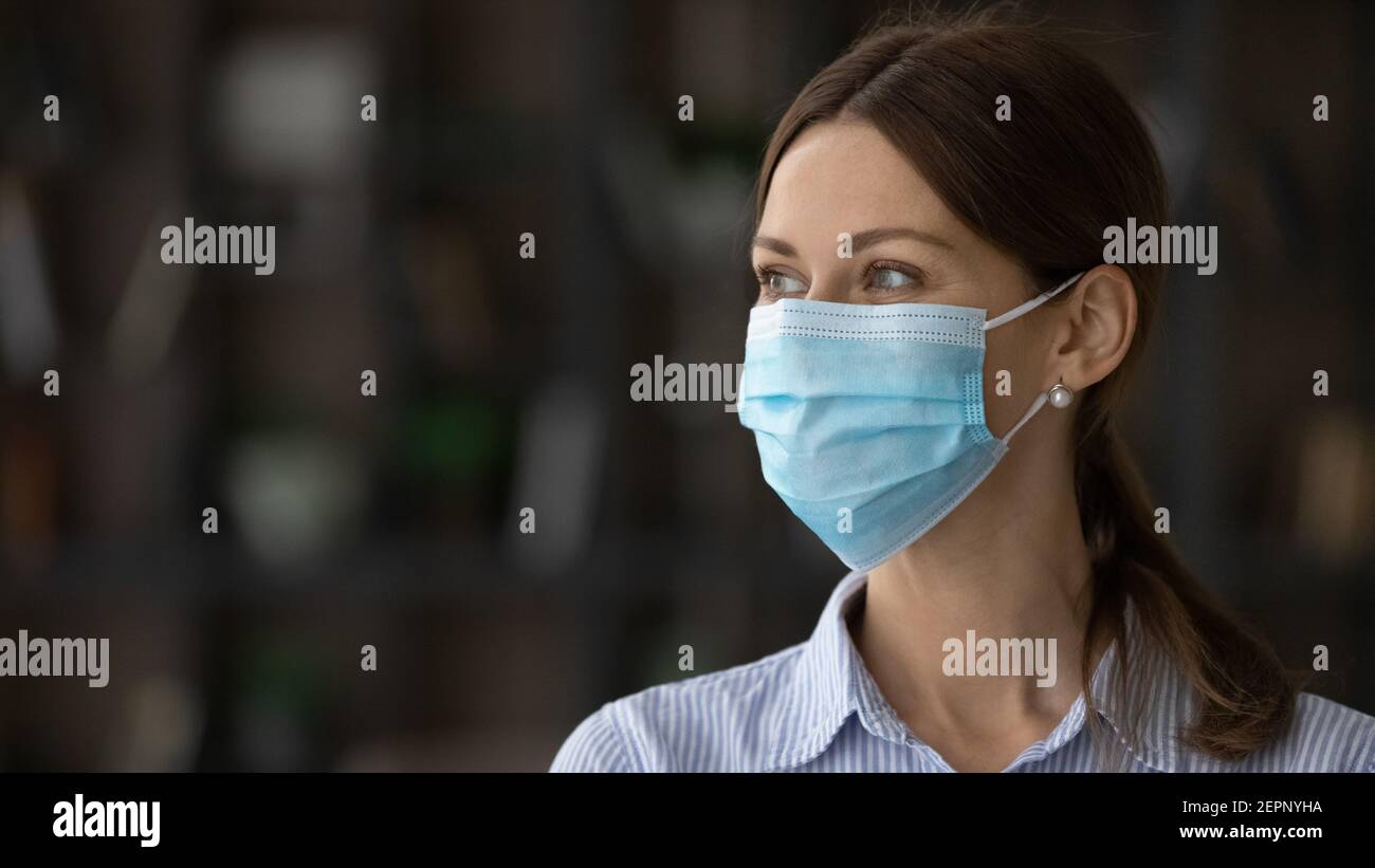 Woman employee in facemask hi-res stock photography and images - Alamy
