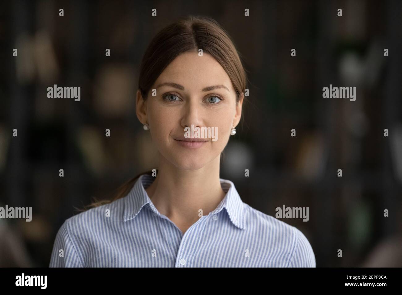 Headshot portrait of smiling young Caucasian woman posing Stock Photo
