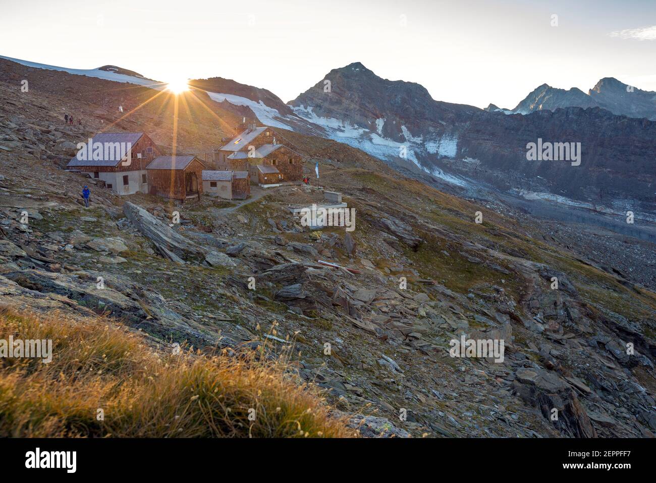 Defreggerhaus alpine refuge. Sunlight at sunrise. Venediger group. Austrian Alps. Europe. Stock Photo