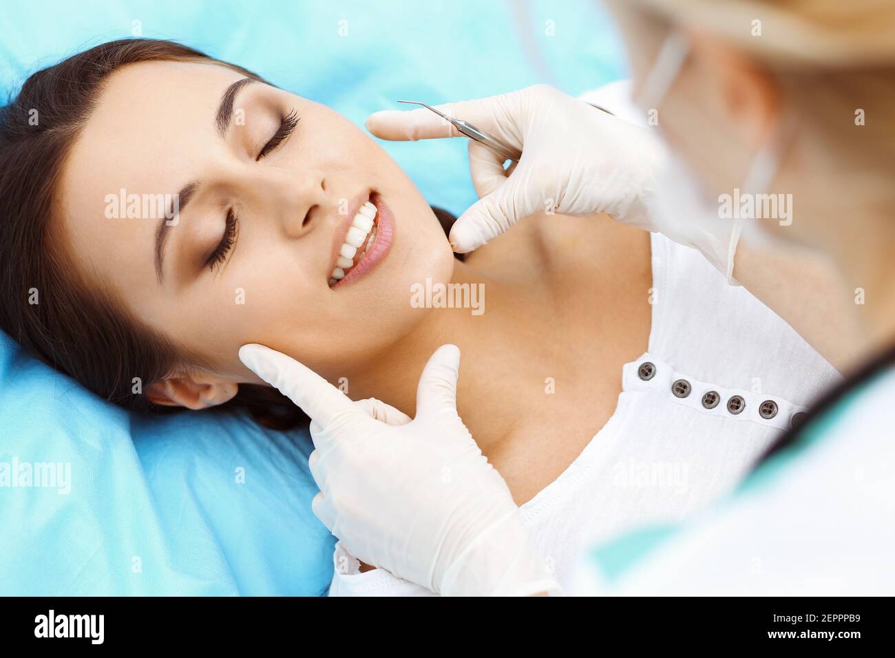 Young female patient visiting dentist office.Beautiful woman with