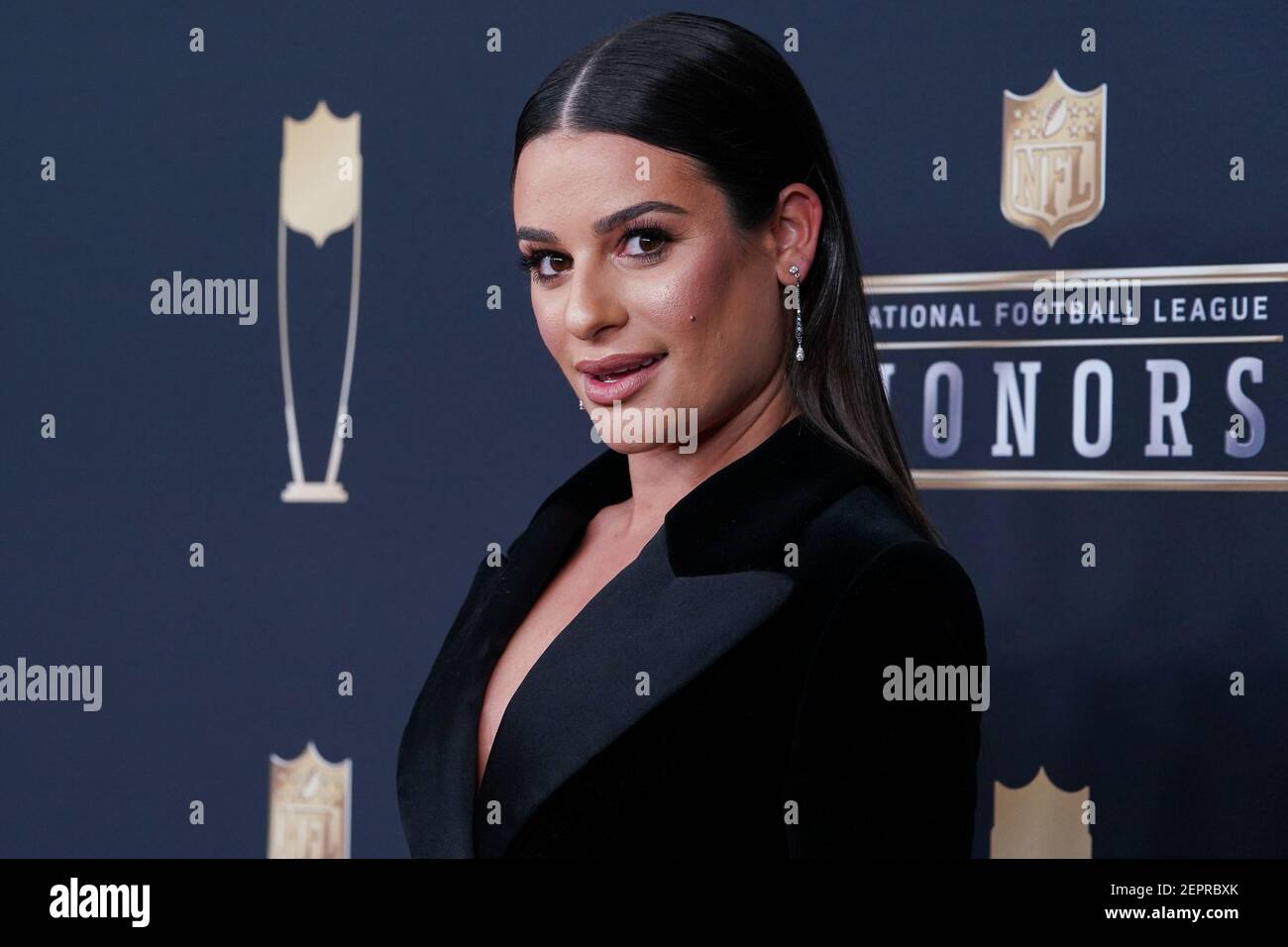 Lea Michele walking on the red carpet the NFL Honors held at the Cyrus