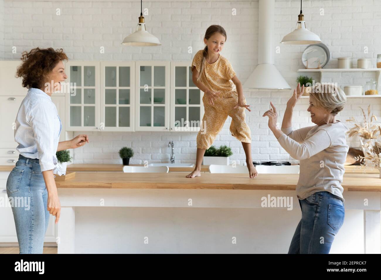 Energetic granny mom girl dancing on funny party at home Stock Photo