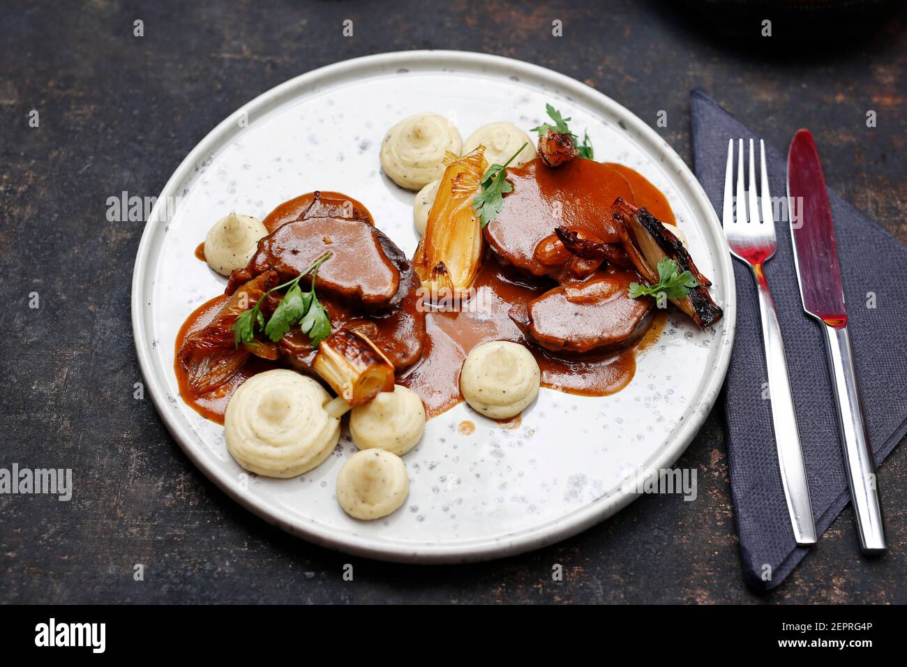 dinner. Meat in gravy with white vegetable puree. Food served on a plate, food styling, serving suggestions, culinary photography. Stock Photo