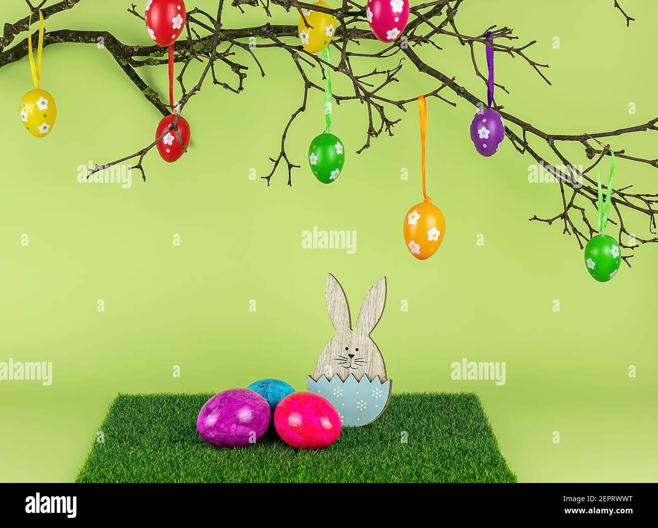 Easter tree, wooden bunny, and colored eggs. Holiday composition. Stock Photo
