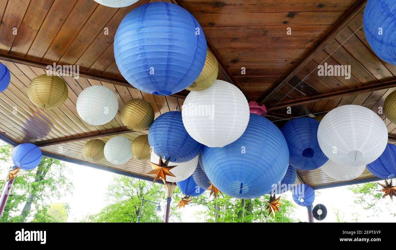 Bandstand Ceiling in Park Decorated with Blue, White and Gold Paper Lanterns for Local Summer Music Festival, Pretty Outdoors Ball Decorations Stock Photo