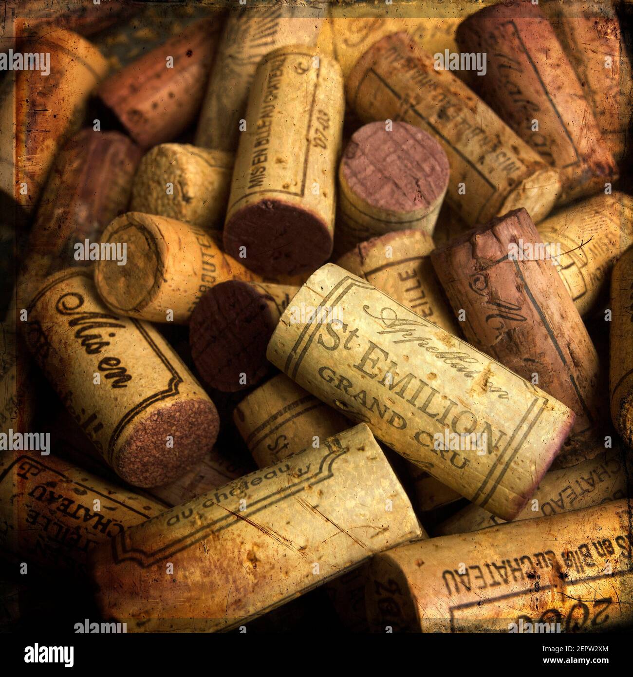 A collection of vintage french wine corks showcasing different brands and years, emphasizing craftsmanship and aged character in a cozy setting Stock Photo