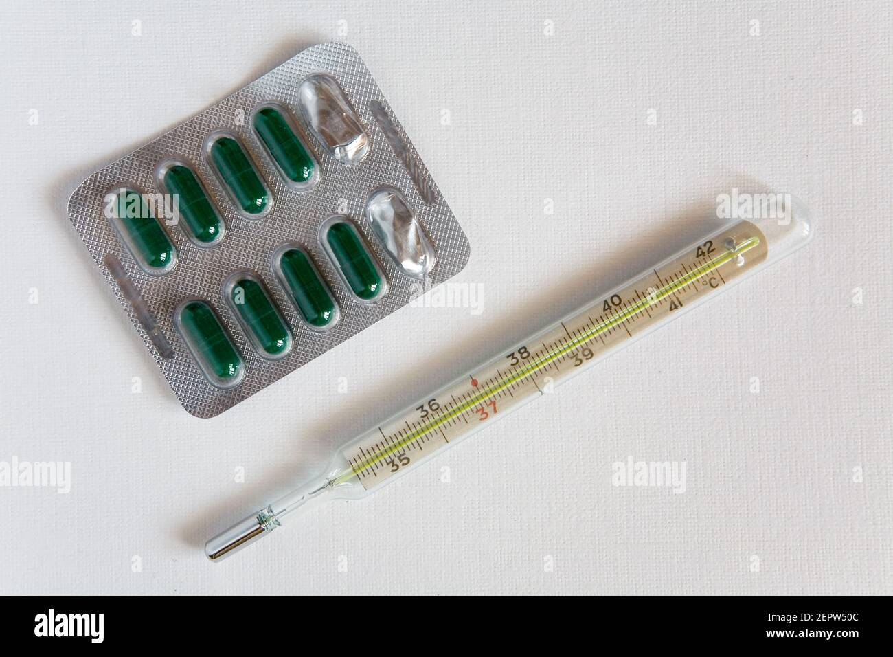 Medical thermometer and pill packaging. Medical devices and drugs. Stock Photo