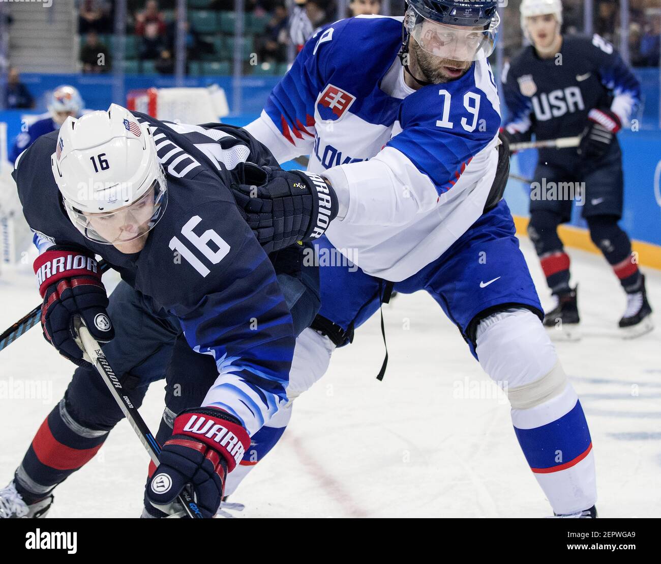 The United States' Ryan Donato (16) and Slovakia's Tomas Starosta (19) battle for the puck in the first period during group play on Friday, Feb. 16, 2018, at South Korea's Gangneung Hockey Centre in the Pyeongchang Winter Olympics. (Photo by Carlos Gonzalez/Minneapolis Star Tribune/TNS/Sipa USA) Stock Photo