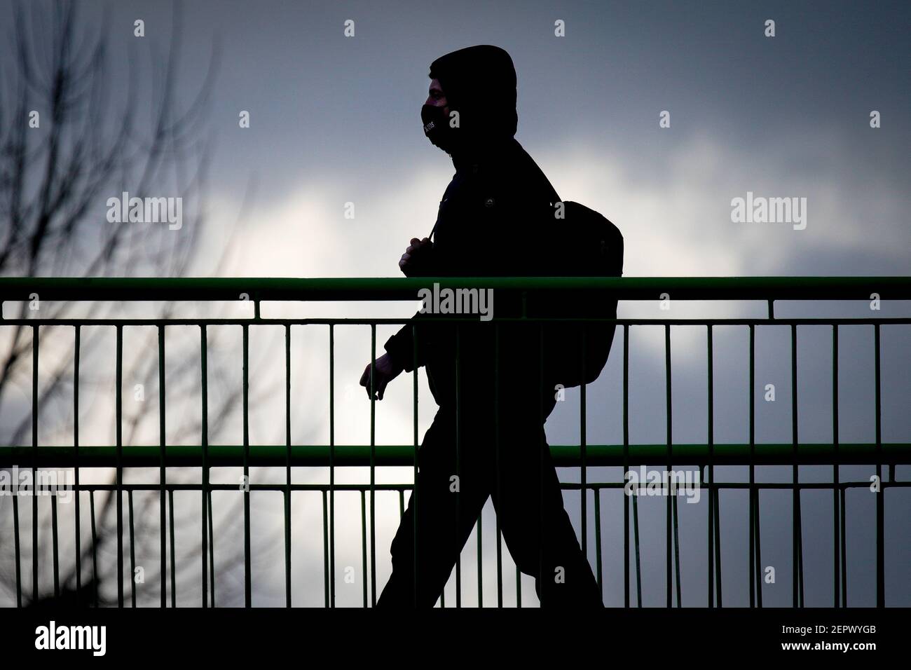 (210228) -- WARSAW, Feb. 28, 2021 (Xinhua) -- A man wearing a face mask is seen crossing a bridge in Warsaw, Poland, on Feb. 27, 2021. The Polish government announced new restrictions on Wednesday in an effort to curb a recent rise in new COVID-19 infections officially dubbed the 'third wave.' Health Minister Adam Niedzielski said that the rules on face covering will be tightened, mandating the use of masks in public spaces starting on Saturday instead of the previously allowed alternatives, such as scarfs and visors. Also starting on Saturday, travelers from southern neighbours Slovakia Stock Photo