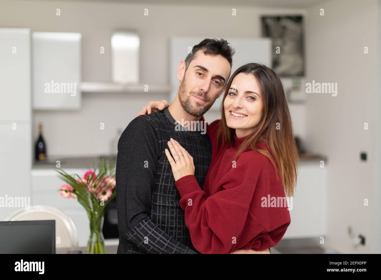 Happy couple hugging in their home Stock Photo - Alamy