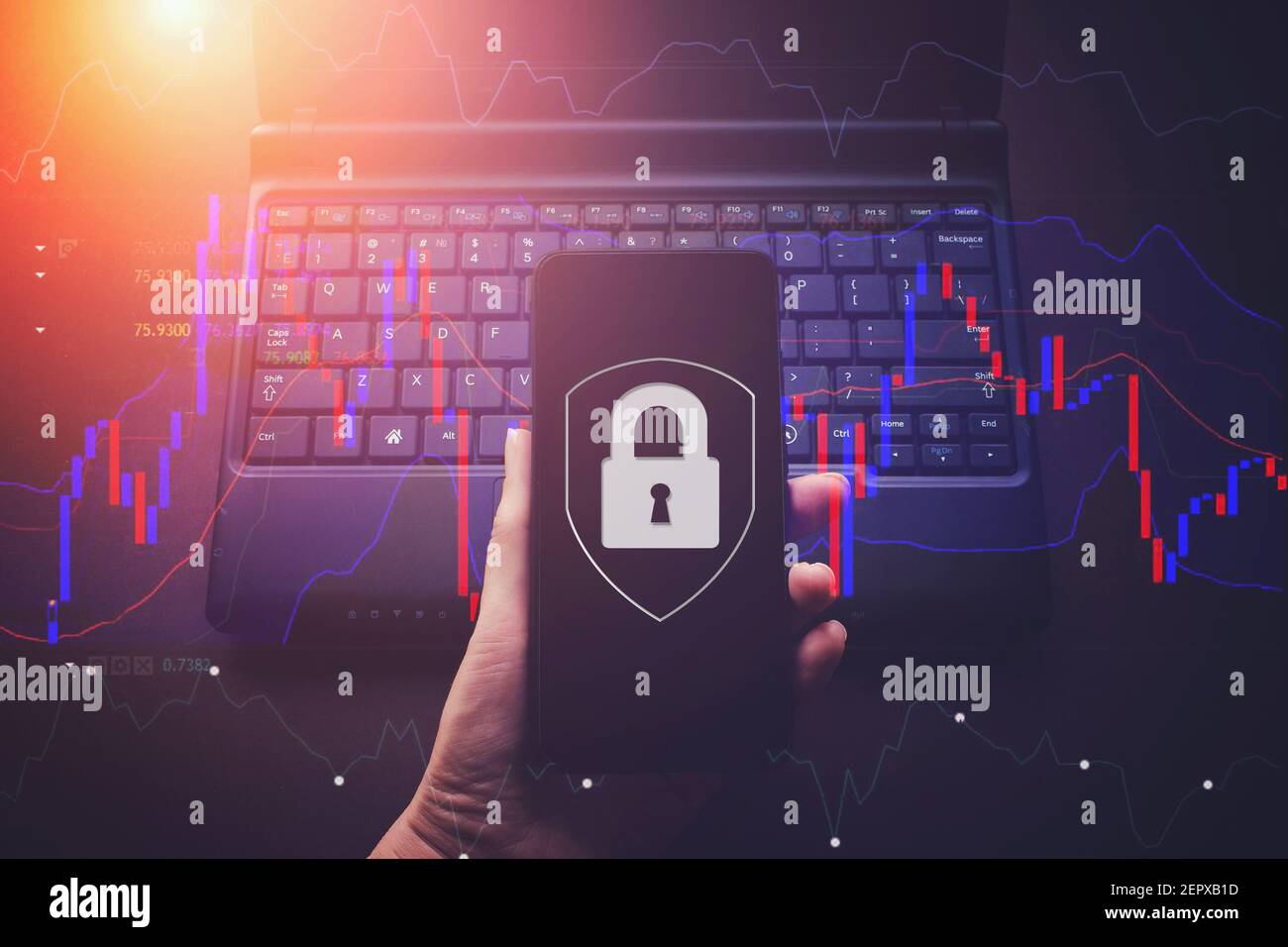 Hand hold phone with Virtual hologram padlock on laptop notebook background, data protection and insurance. The concept of business security, informat Stock Photo
