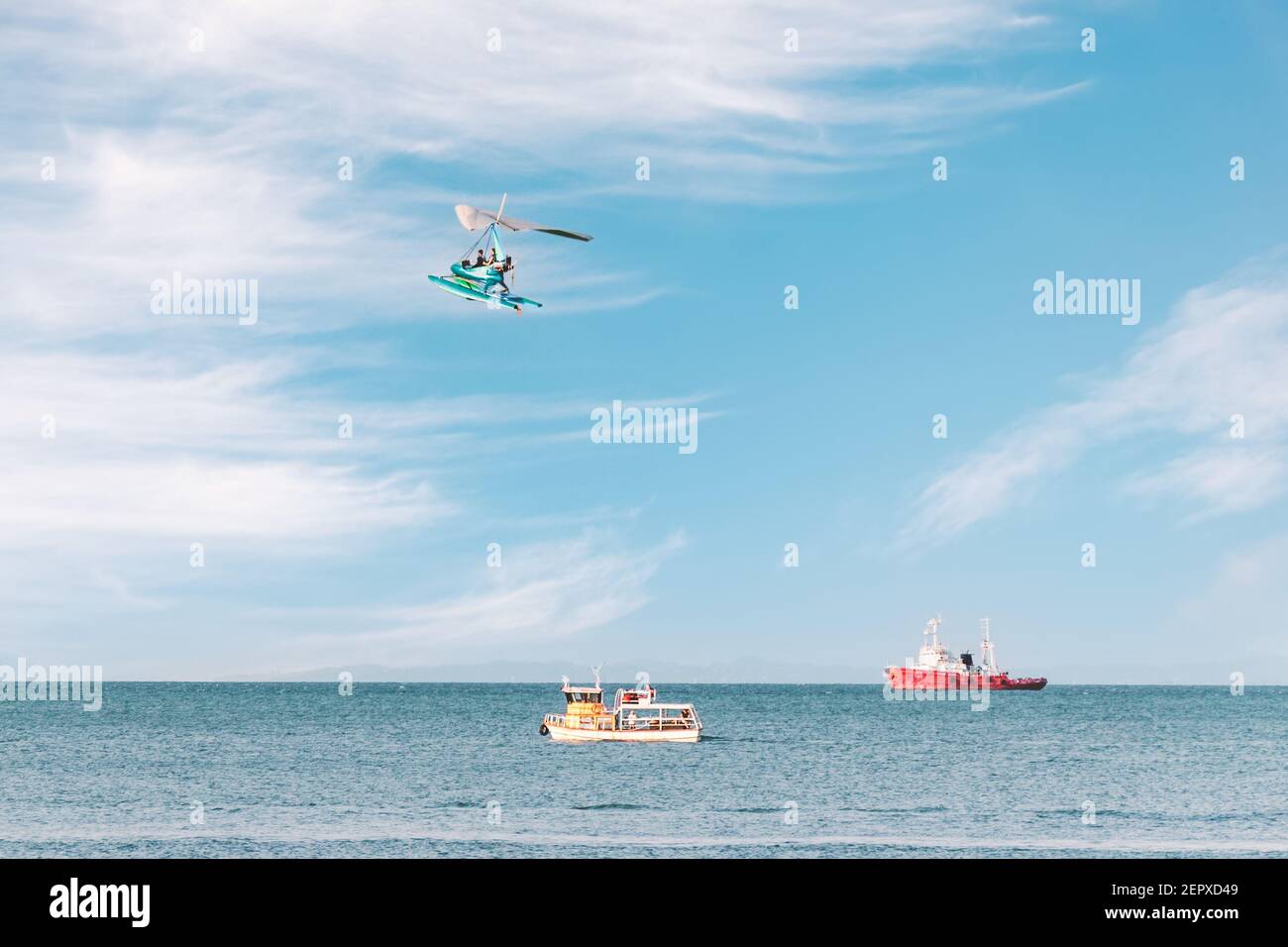 Side view of the sea with pleasure ships and a flying paraglider. Fun