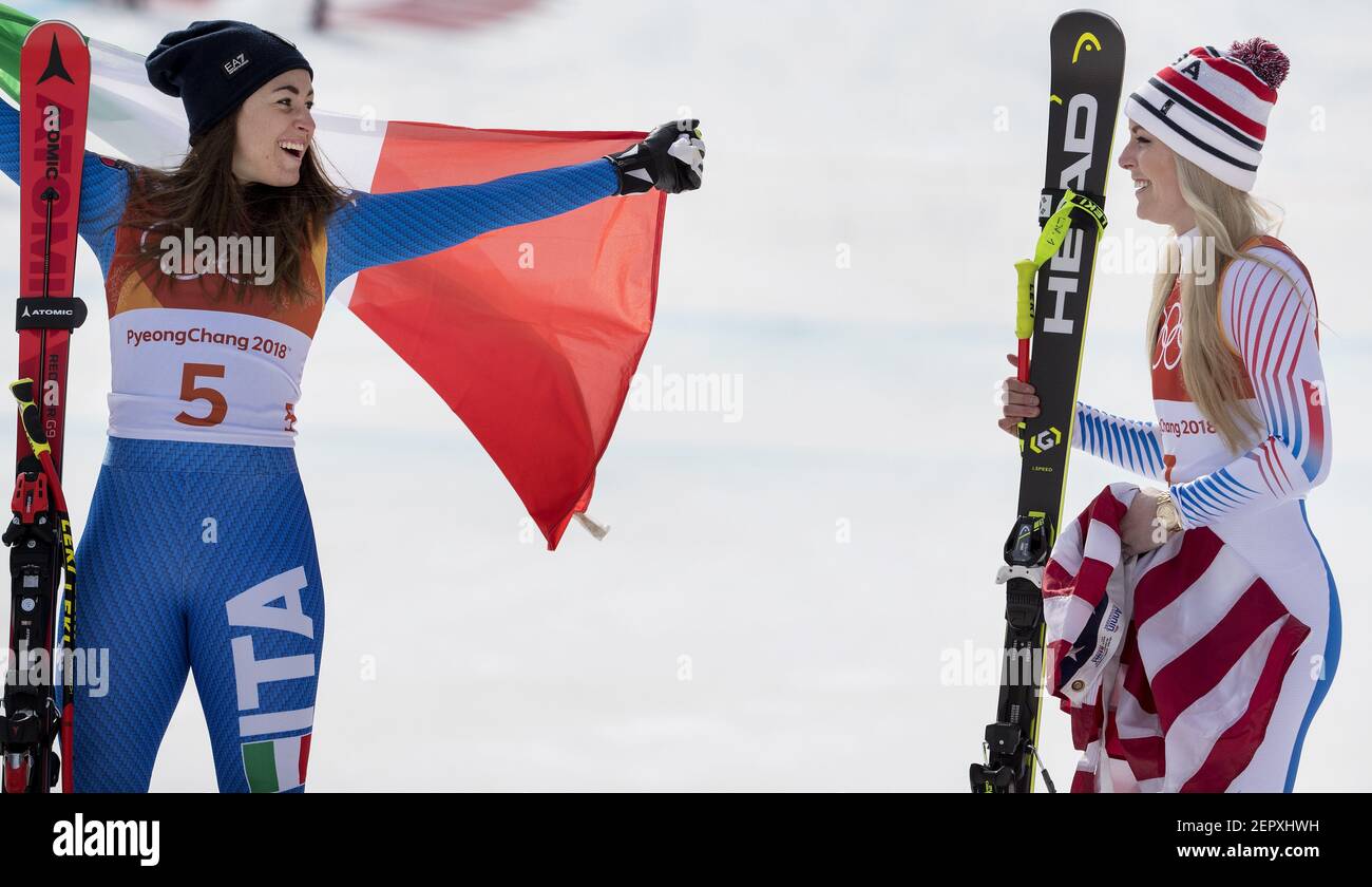 Italy's Sofia Goggia, left, celebrates her gold medal with Lindsey Vonn