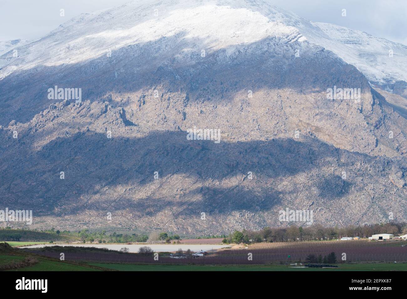Winter agricultural landscape scenic view onto snowcapped mountains in the Ceres valley, Western Cape, South Africa Stock Photo
