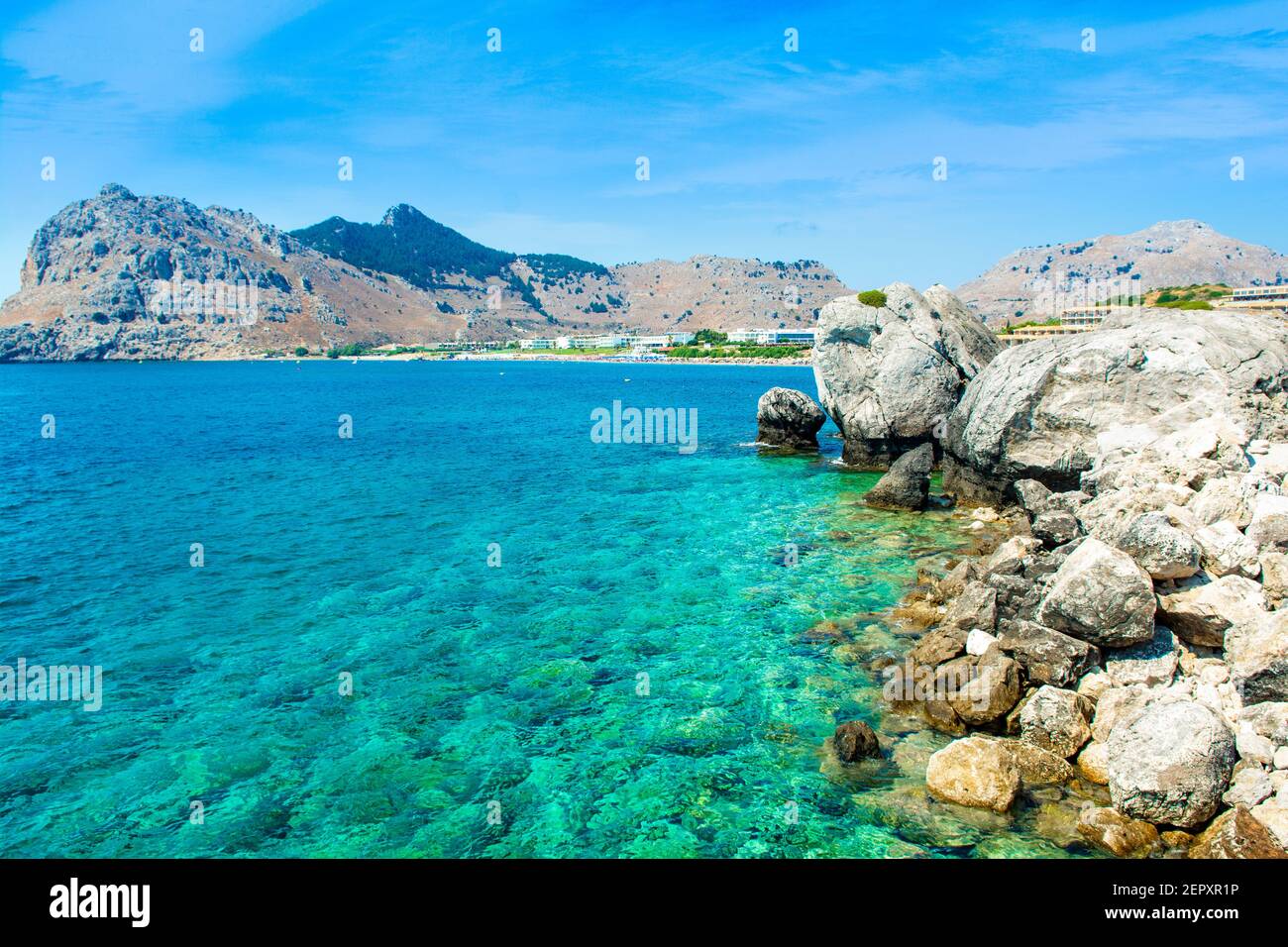 Landscape of beautiful Kolymbia bay in Rhodes island with mountain and rocky beach Stock Photo
