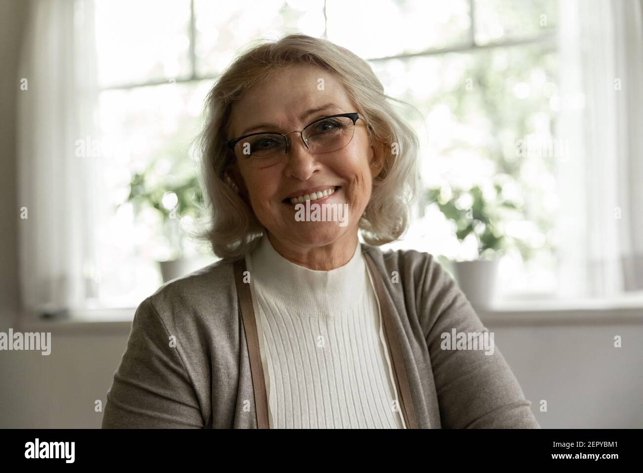 Photo portrait of happy elder OAP 60s woman wearing glasses Stock Photo