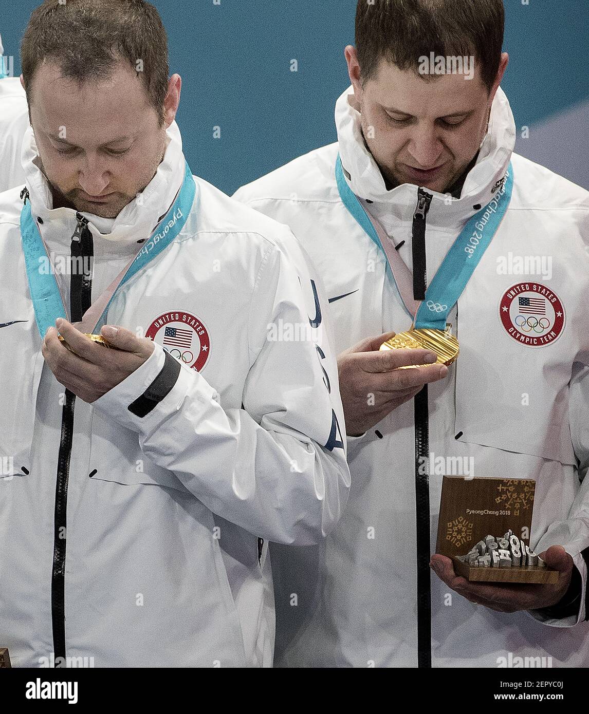 Tyler George and John Shuster of Team USA look at gold medals after a 10-7 win against Sweden on Saturday, Feb. 24, 2018, at the Pyeongchang Winter Olympics' Gangneung Curling Centre. (Photo by Carlos Gonzalez/Minneapolis Star Tribune/TNS/Sipa USA) Stock Photo