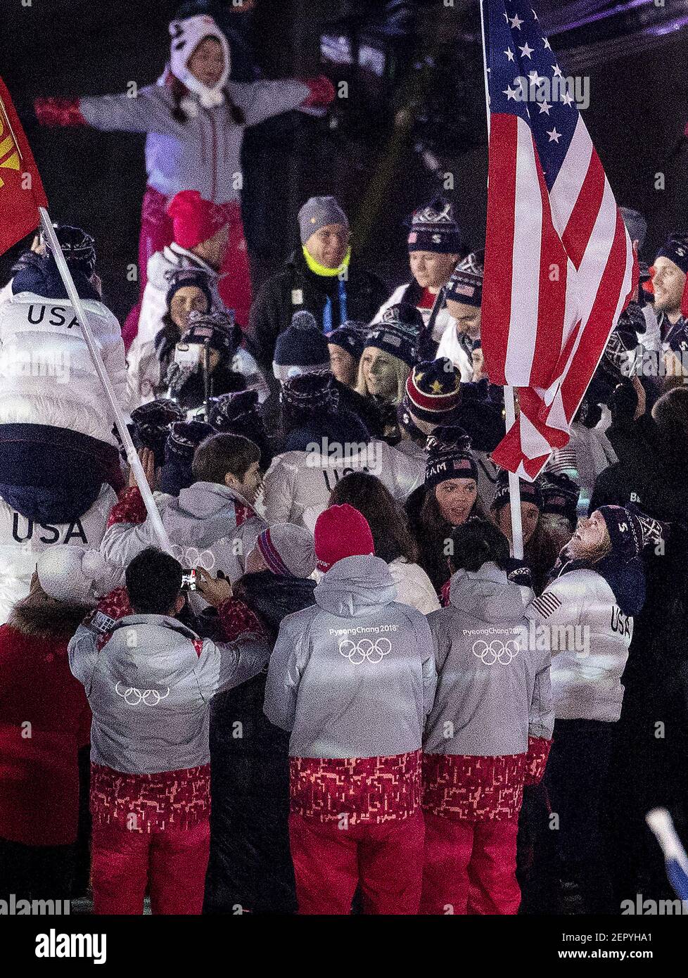 Jessie Diggins carries the flag for Team USA at the Closing Ceremony of