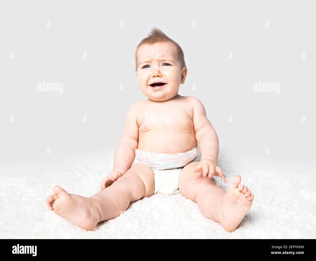A crying baby on a white background. Stock Photo