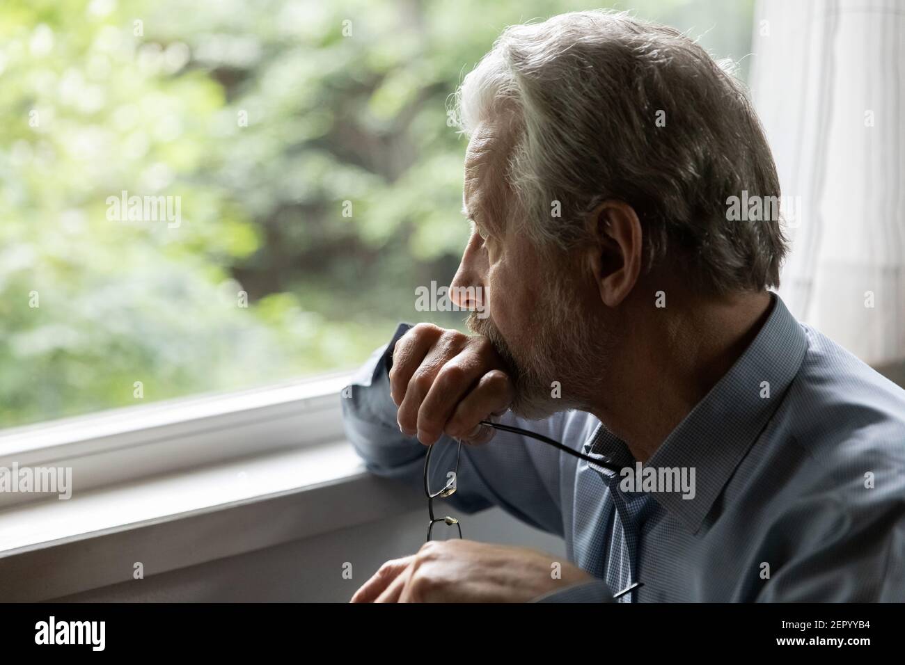 Pensive mature 70s aged man in deep thoughts Stock Photo
