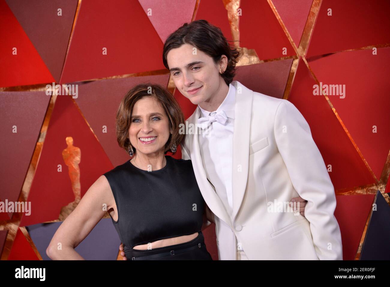 Timothée Chalamet with his mom walking on the red carpet during the ...