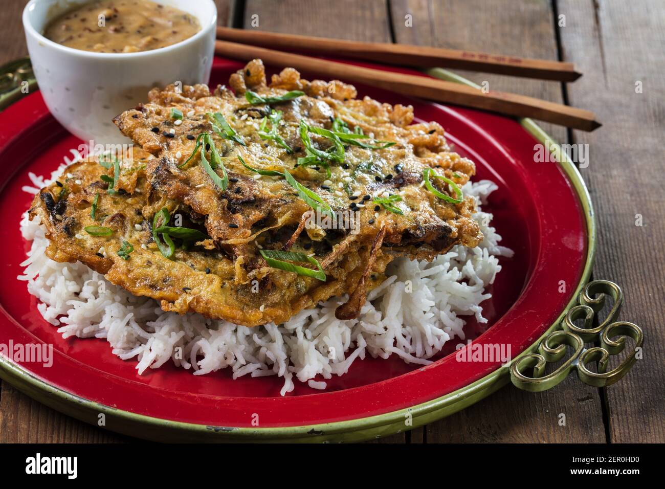 Egg foo young with mushrooms and bean sprouts, served over rice with a