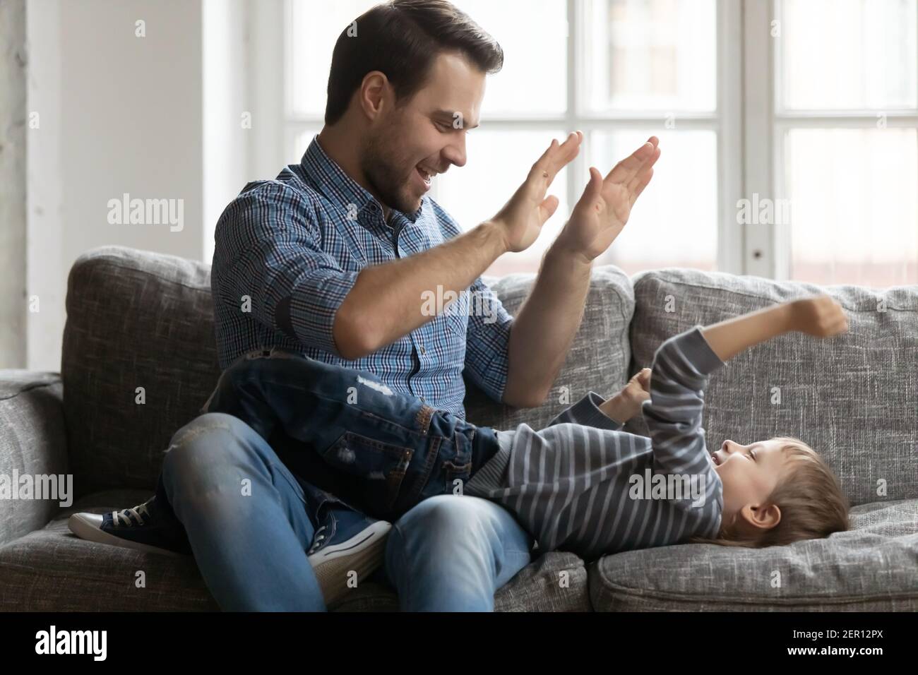 Happy father giving high five to cute preschooler son Stock Photo