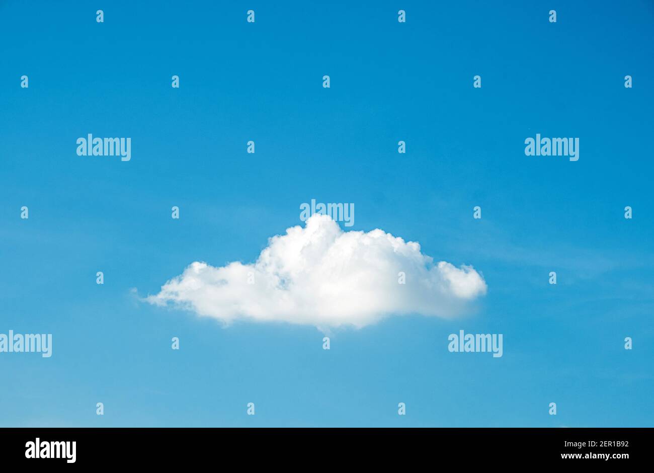 Cute fluffy shape single cloud on clear blue sky background. Stock Photo