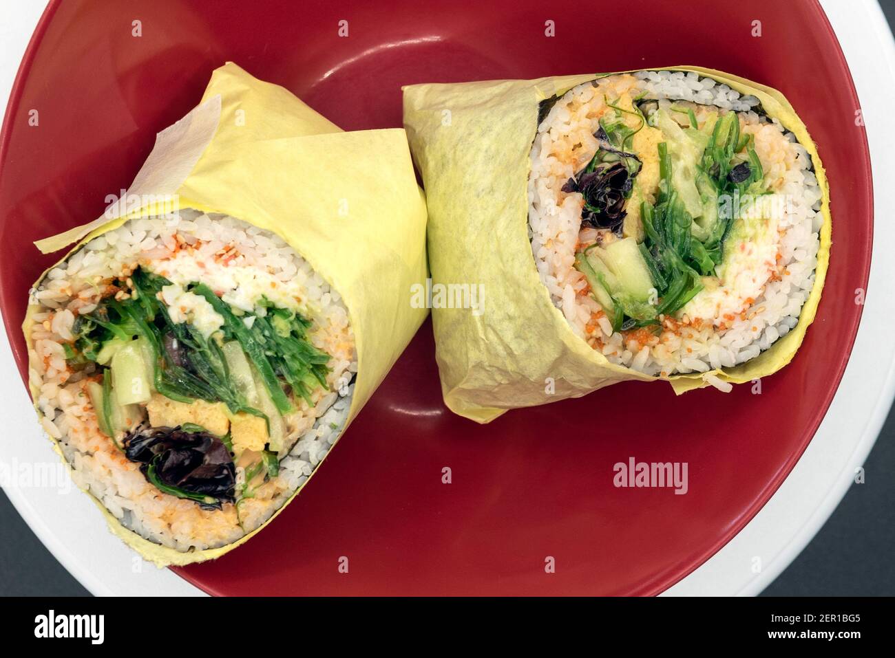 Overhead view of Tuna Poke burrito Pokerito wrapped with rice, fish
