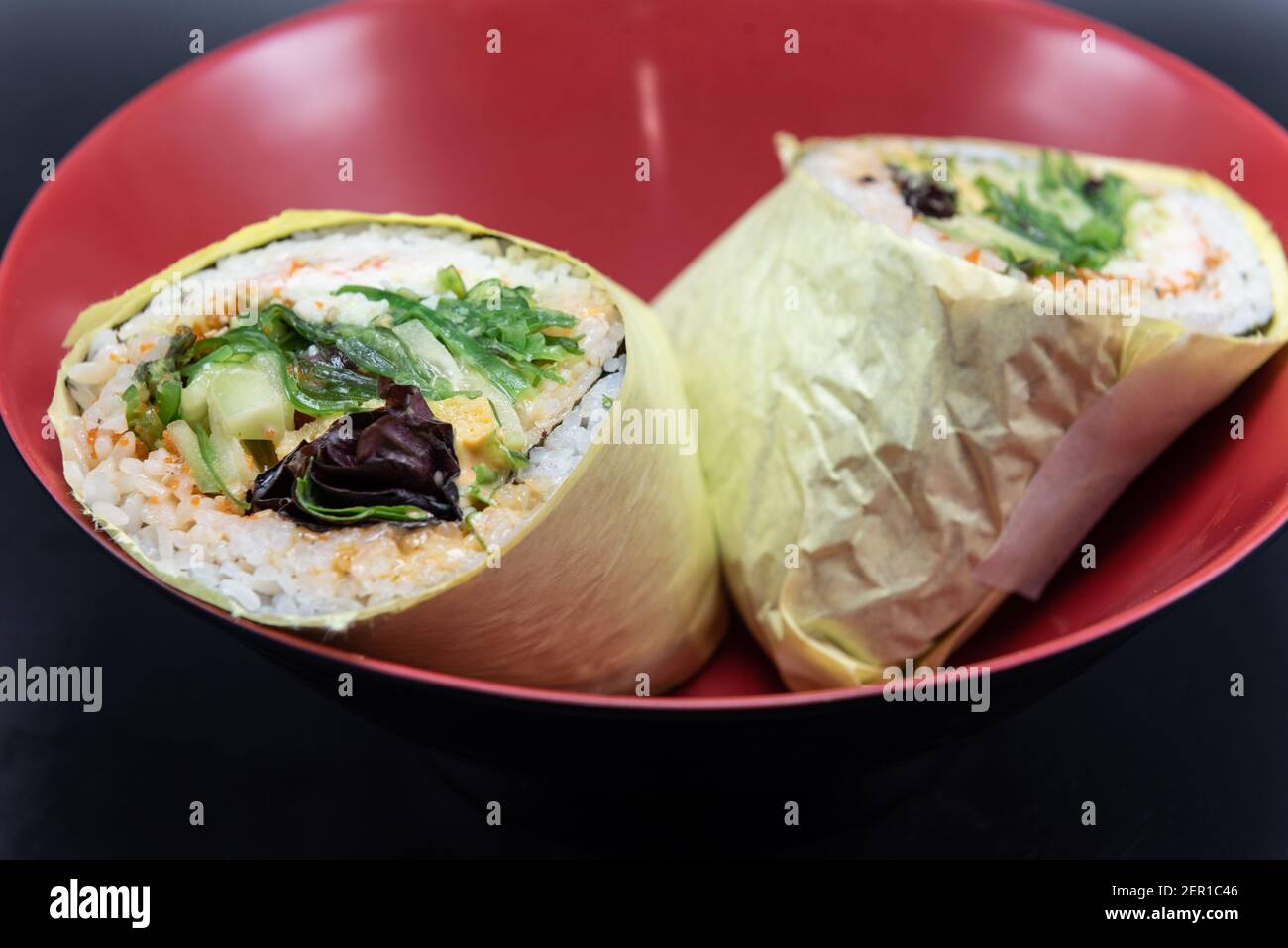 Tuna Poke burrito Pokerito wrapped with rice, fish, veggies all served in a bowl. Stock Photo